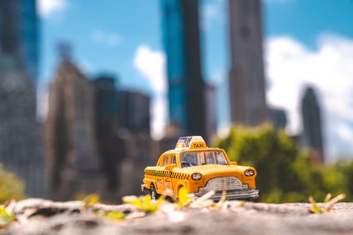 A closeup shot of a model taxi car in Central Park, New York, USA
