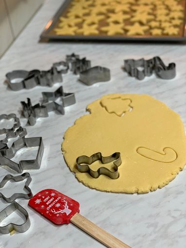 A vertical shot of making Christmas cookie and shaping with different forms