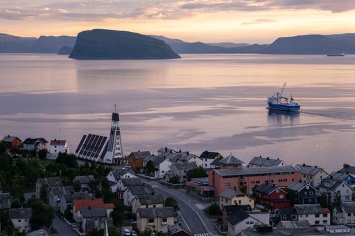 Hammerfest, Norway - July 26, 2022: Beautiful scenery of Hammerfest town and surroundings on the Kvaloya Island during sunset. Summer cloudy day.