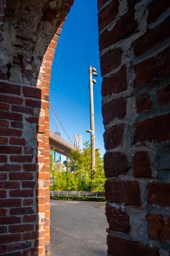 A vertical shot of the Brooklyn Bridge from a building in New York, USA