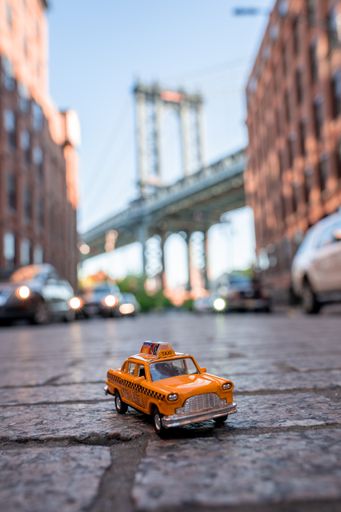 A vertical shot of a taxi model on Washington street in New York, USA