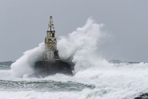 Huge waves hit the lighthouse during severe sea storm