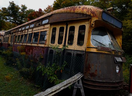 An old rusty train surrounded by trees in Toronto