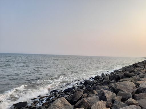The rocky beach view with the sea water touching the stones