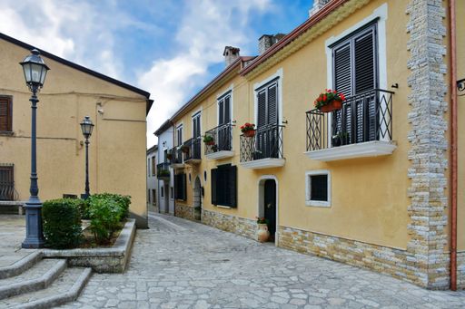A narrow street between the houses of Frigento, a rural village in the province of Avellino in Italy.