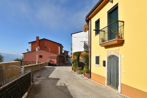 A narrow street between the houses of Frigento, a rural village in the province of Avellino in Italy.