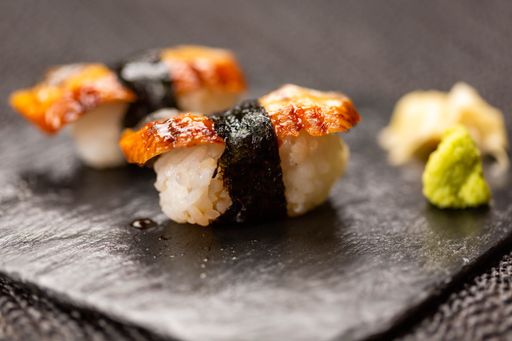 A closeup shot of a board with gourmet delicious sushi rolls