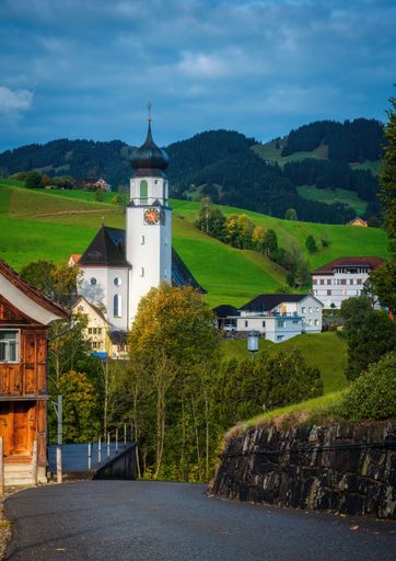 A vertical shot of the old parish church of St. John the Baptist in the green hills