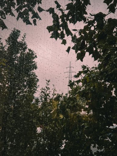 A vertical shot of the wet window glass on a rainy day in Zagreb, Croatia.