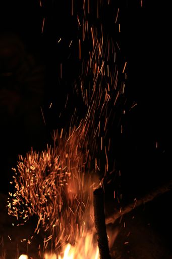 A closeup of fire sparks, fire flame on the black background