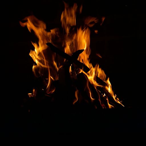 A closeup shot of a large burning orange fire at night