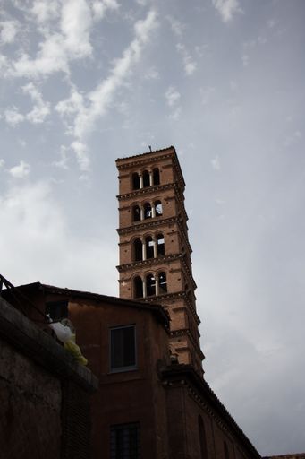 A vertical low angle shot of the Basilica of Saint Mary in Cosmedin under a bright sky in Rome, Italy