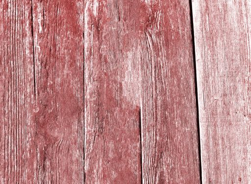 A closeup of an old weathered red painted wood texture