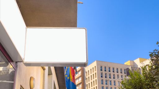 A closeup view of a blank advertising board on a building-  mockup for design