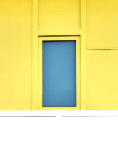 A yellow building with blue window