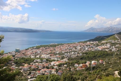 An aerial view of the Adriatic coastline and the cityscape, with a blue sky in the background Makarska, Croatia