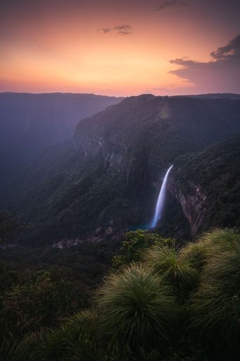 A vertical shot of Nohkalikai Falls at sunset. State of Meghalaya, India.