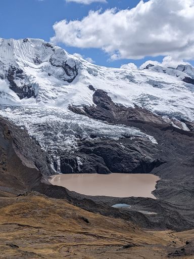 A vertical shot of a small lake in mountains
