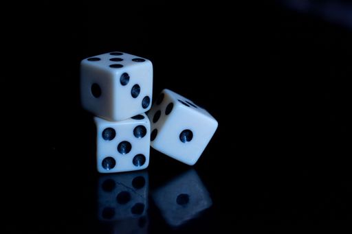 A closeup shot of three dice on a black background
