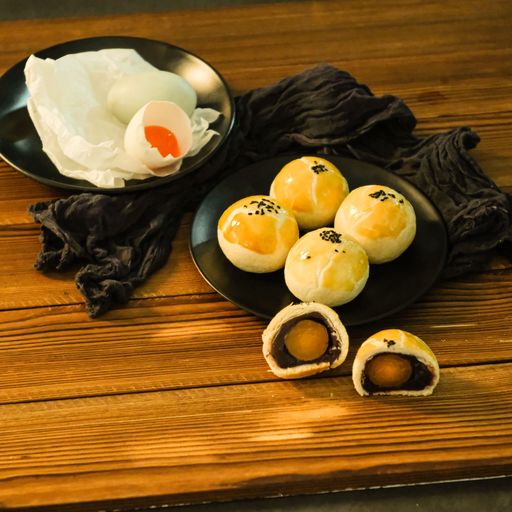 A closeup shot of salted egg yolk pastry served on a black plate