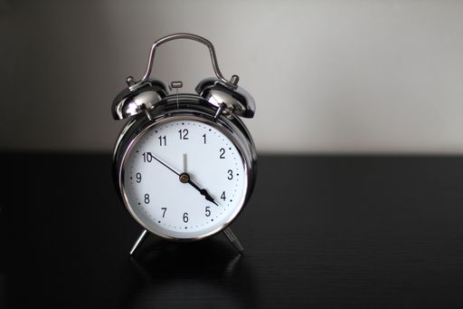 A closeup shot of a clock on a black table