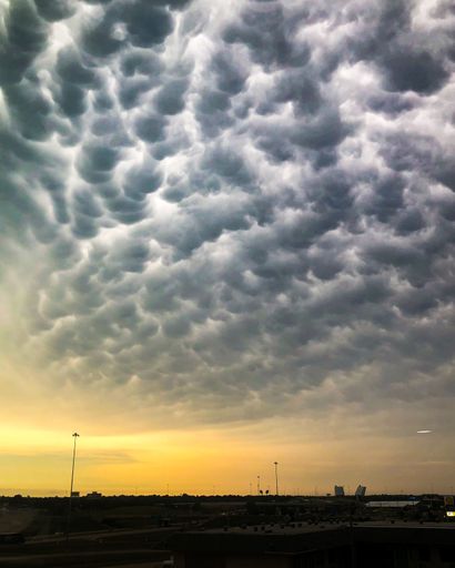 A vertical shot of the wild clouds over Oklahoma City at sunset