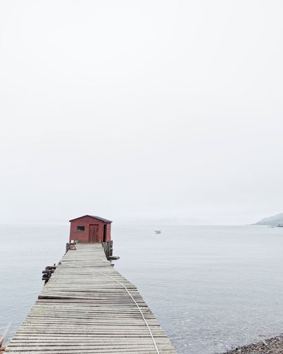 Iconic traditional red colored wooden fishing stages that are a part of the fishing culture of Newfoundland and Labrador, Canada.