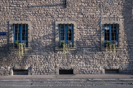 Three windows in a stone house
