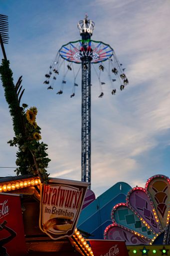 A vertical shot of a big ride in the amusement park in Munich during the Oktoberfest festival