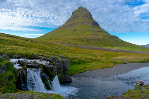 A beautiful view of Mount Kirkjufell framed by a silky long exposure waterfall in Iceland