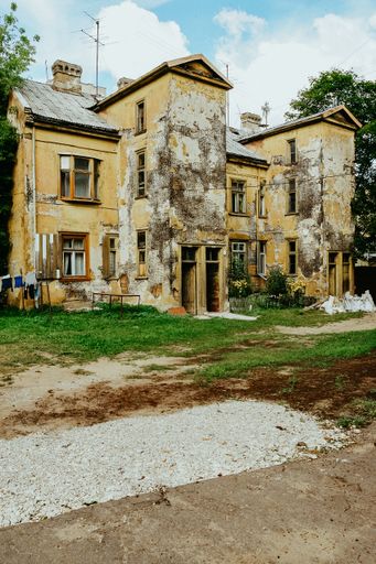 A vertical shot of an old abandoned house