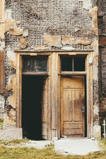 A vertical shot of an old abandoned house