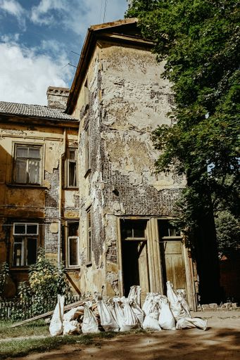 A vertical shot of an old abandoned house