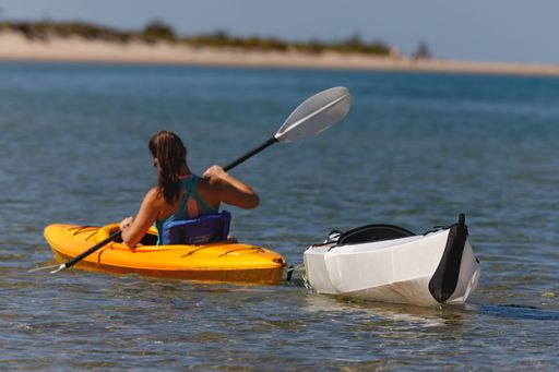A woman kayaking near the shore in closeup