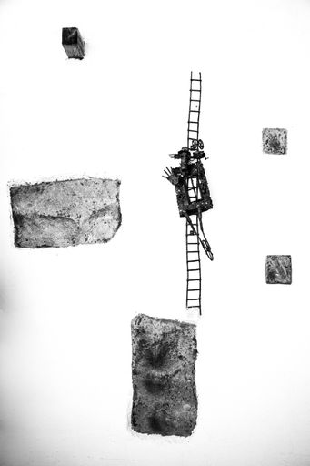 A vertical shot of pieces of wood, stones and a ladder with decors on a white surface