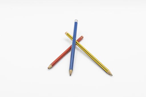 A closeup shot of three pencils on a white background