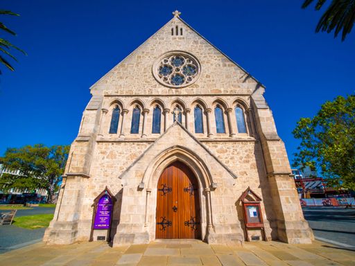 A low angle shot of church building facade under blue bright sky in Fremantle