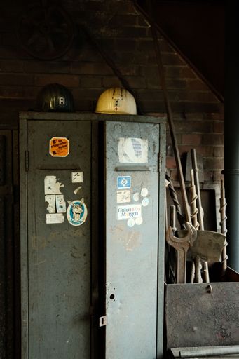 A vertical shot of the miner's helmets on an old locker in a mine in the Ruhr area, Germany