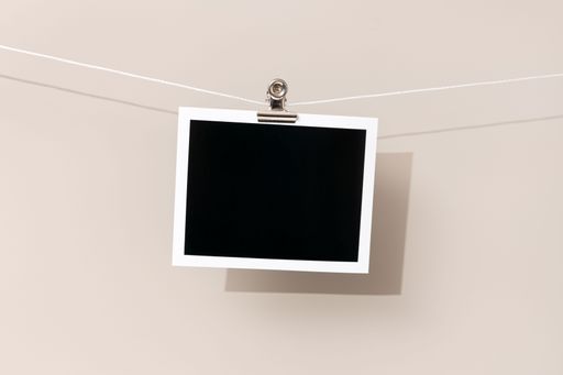 Blank Vintage instant photo frame hanging on a rope. Template