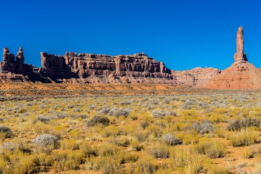 The rock formations in the Valley of the Gods under the sunlight and a blue sky in Utah, the US