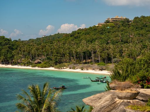 The boats on the turquoise water with green vegetation in the background. Holiday in Thailand, Koh Tao.