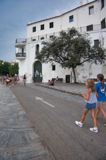Two girls walking on the street of Cadaques, Catalonia in Spain