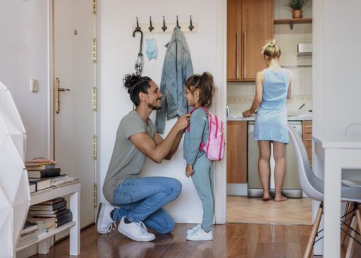 A father talking to her daughter before taking her to school - back to school