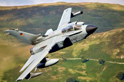 Panavia Tornado aircraft flying low over a green landscape