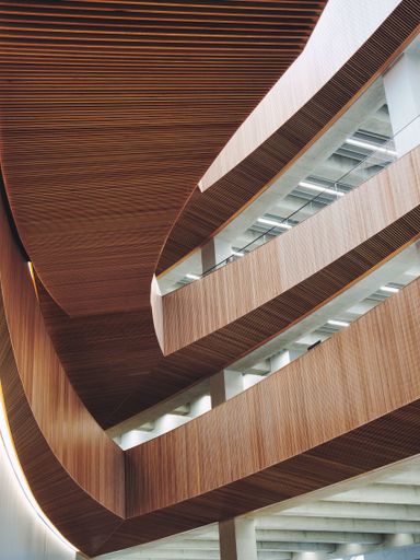 A low-angle closeup of a Central Library with wooden and white decorative parts