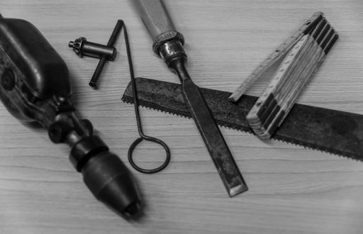 An overhead shot of different instruments and a meter on a gray surface