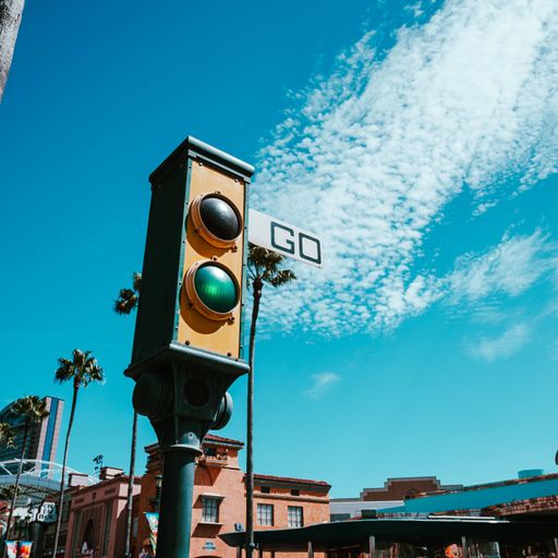 A close-up shot of a traffic light with the background of the sky