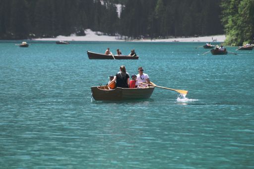 People enjoying some time off by rowing a boat on Lake Braies in the Italian Dolomites