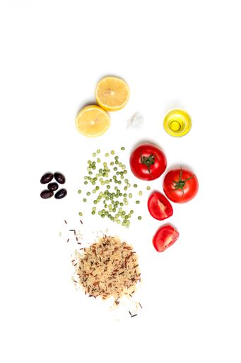 A flat lay  of raw, healthy ingredients for vegetarian diet on white surface