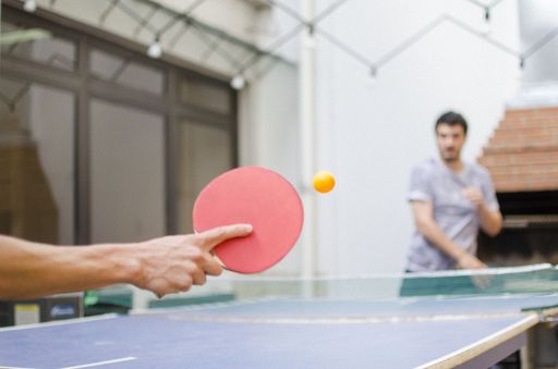 A closeup to a sportsman's hand playing table tennis